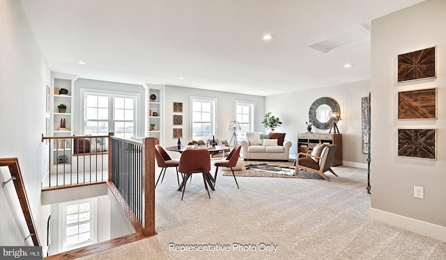 living room with light carpet and built in features