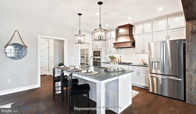 kitchen featuring white cabinetry, stainless steel appliances, decorative light fixtures, and custom exhaust hood