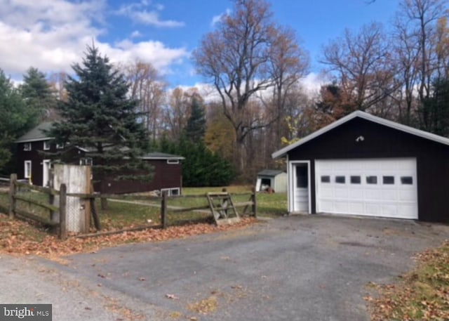 view of side of home with a garage and an outdoor structure