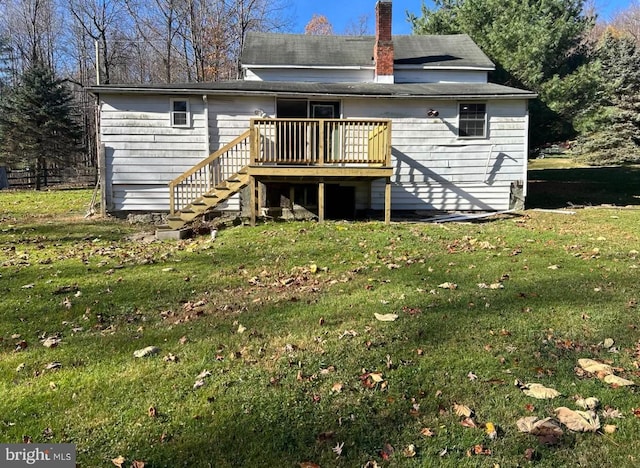 back of property with a lawn and a wooden deck