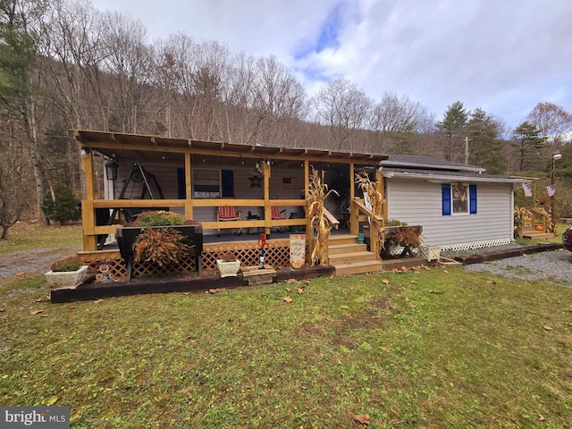 view of front of property with solar panels and a front lawn