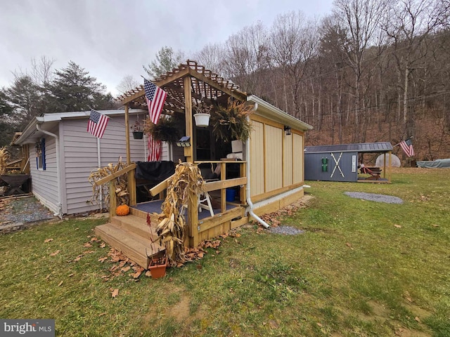 back of house with a shed and a lawn