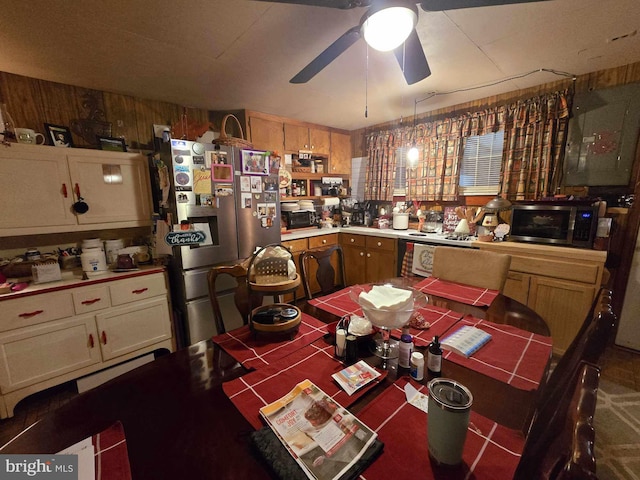 kitchen with ceiling fan, carpet floors, stainless steel appliances, and wooden walls