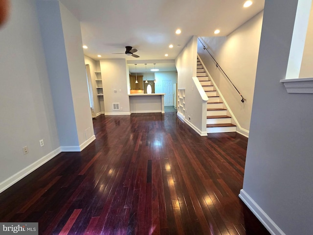 unfurnished living room with dark hardwood / wood-style floors and ceiling fan