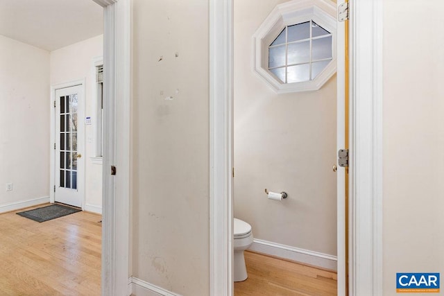 bathroom with hardwood / wood-style floors and toilet