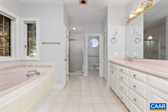 full bathroom featuring tile patterned flooring, vanity, toilet, and independent shower and bath