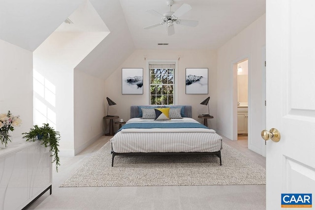 bedroom with light carpet, ensuite bathroom, ceiling fan, and lofted ceiling