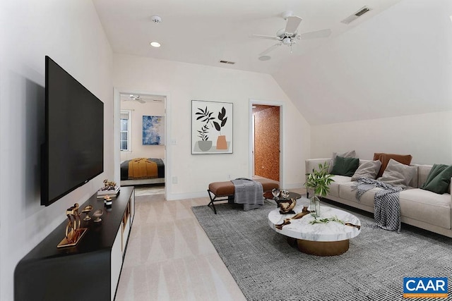 carpeted living room with ceiling fan and lofted ceiling