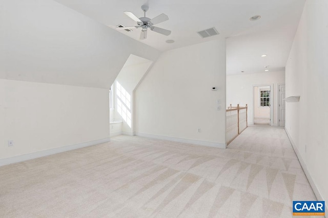 bonus room featuring ceiling fan, light colored carpet, and vaulted ceiling