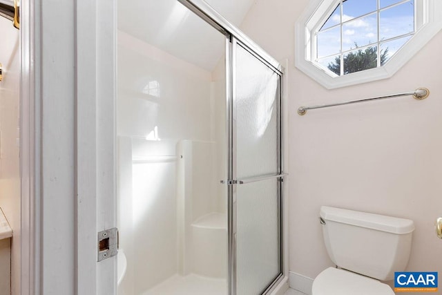 bathroom with toilet and walk in shower