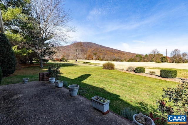 view of yard with a mountain view and a patio