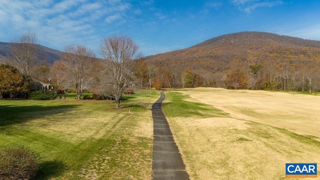 exterior space with a mountain view and a yard