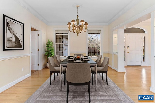 dining room featuring a chandelier, hardwood / wood-style flooring, and crown molding