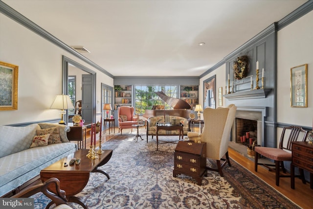 living room with hardwood / wood-style flooring and crown molding