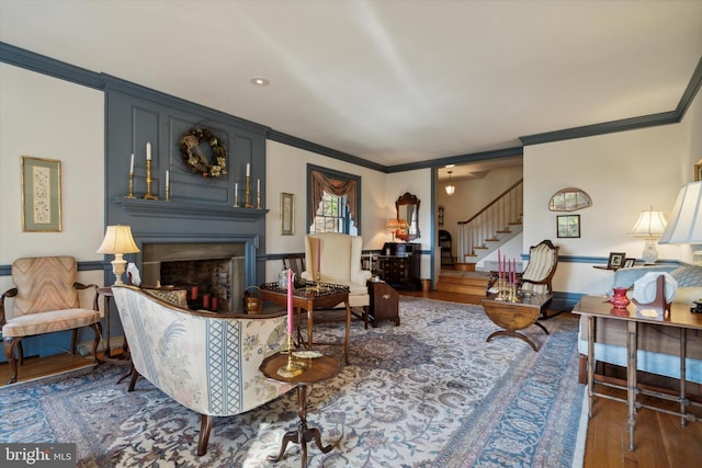 living room with dark hardwood / wood-style floors and crown molding