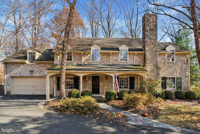 view of front of home featuring covered porch and a garage