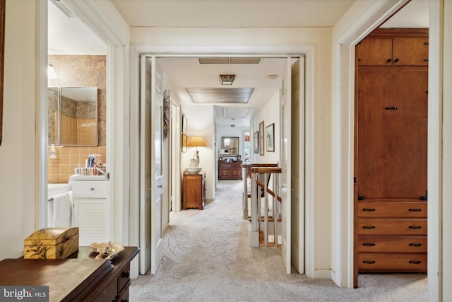 corridor featuring light colored carpet