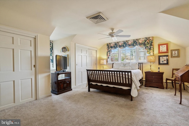 carpeted bedroom with a closet, ceiling fan, and lofted ceiling