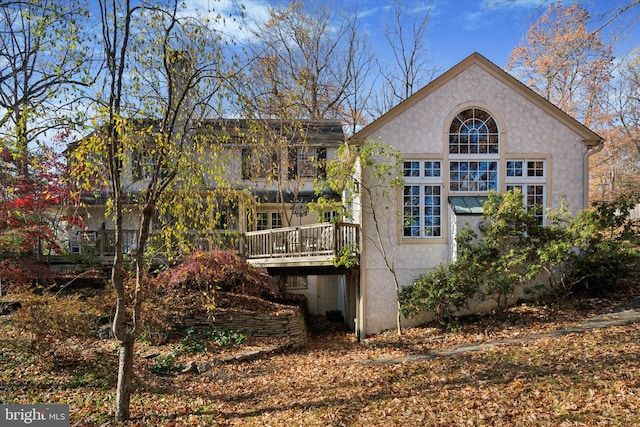 back of house featuring a deck