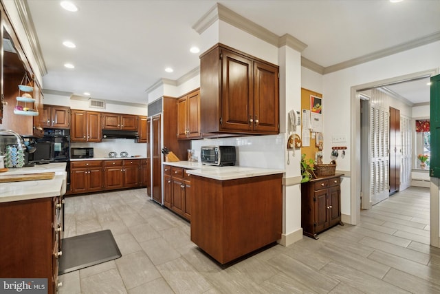 kitchen featuring backsplash, ornamental molding, baseboard heating, sink, and black appliances