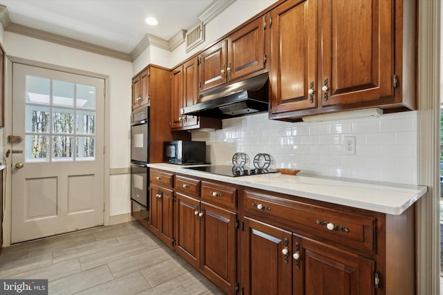 kitchen with tasteful backsplash, black appliances, and ornamental molding