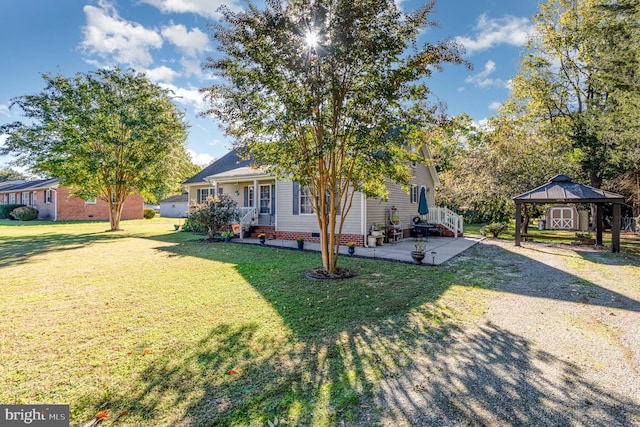 view of front of home with a gazebo and a front lawn