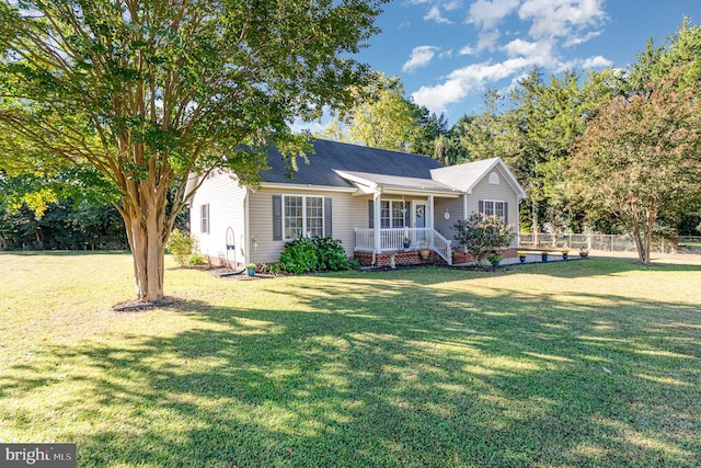 ranch-style home with covered porch and a front yard