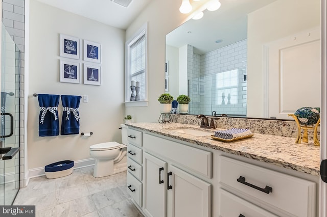 bathroom featuring vanity, toilet, and a shower with shower door