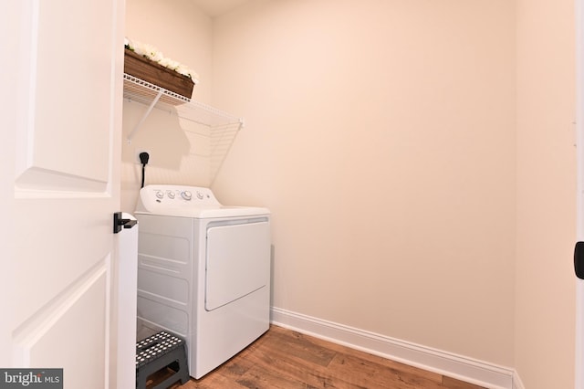 laundry room with hardwood / wood-style floors and washer / dryer