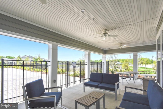 sunroom with ornate columns, ceiling fan, and a healthy amount of sunlight