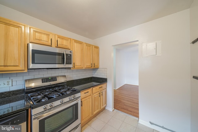 kitchen featuring backsplash, light brown cabinets, light tile patterned floors, and stainless steel appliances