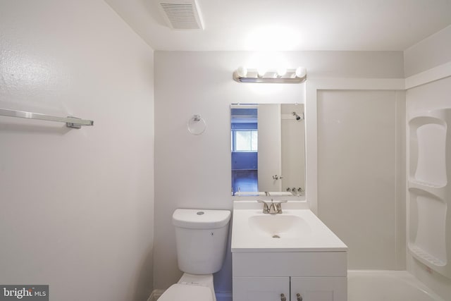 bathroom with vanity, toilet, and a tub