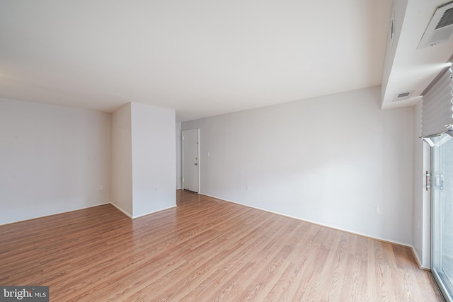 spare room with light wood-type flooring