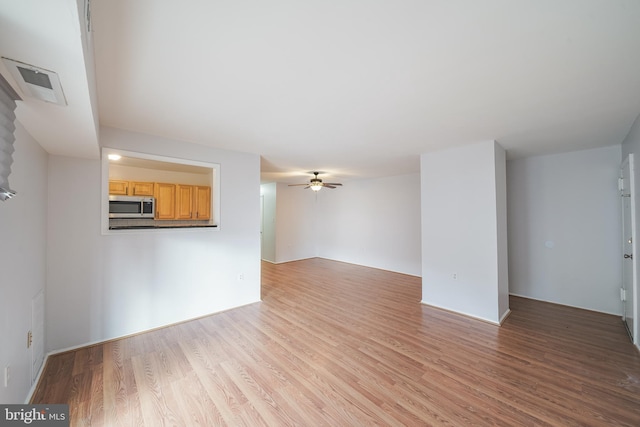 unfurnished living room featuring light hardwood / wood-style floors and ceiling fan