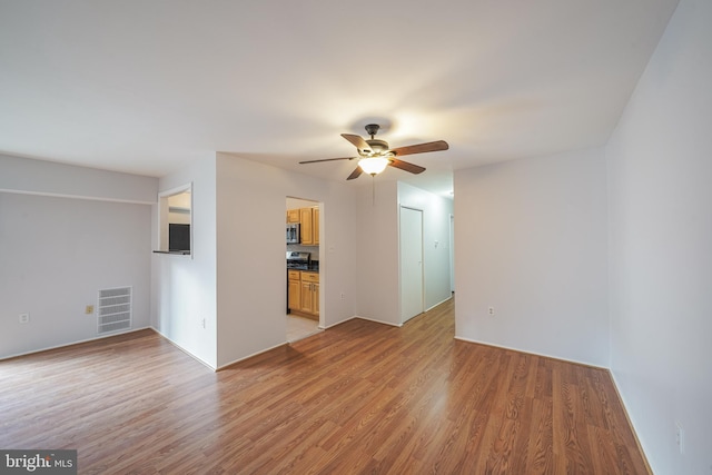 unfurnished living room with ceiling fan and light hardwood / wood-style floors