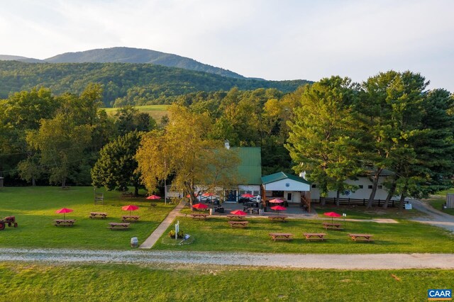 exterior space with a mountain view and a yard