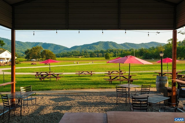 view of home's community with a mountain view and a yard