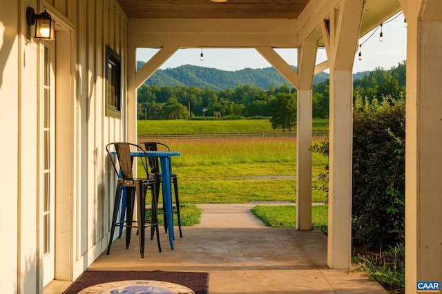 view of patio / terrace featuring a mountain view and a rural view