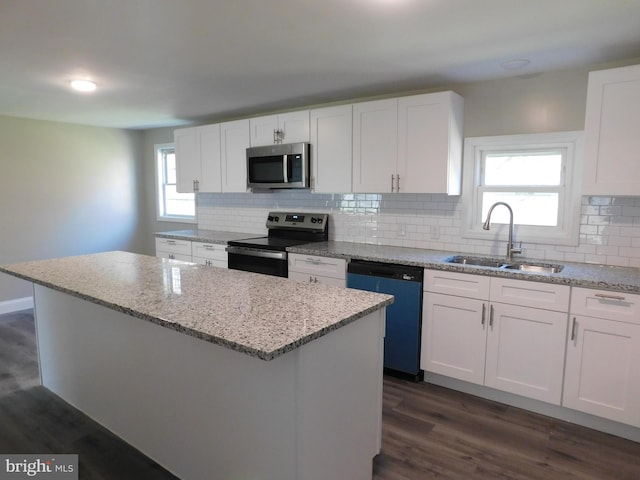 kitchen featuring appliances with stainless steel finishes, white cabinetry, and a kitchen island