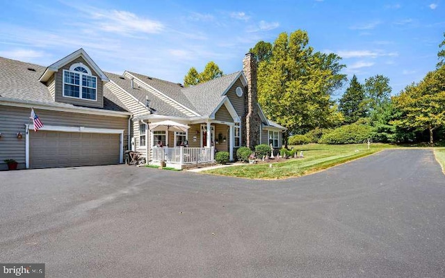 view of front of home featuring covered porch and a garage