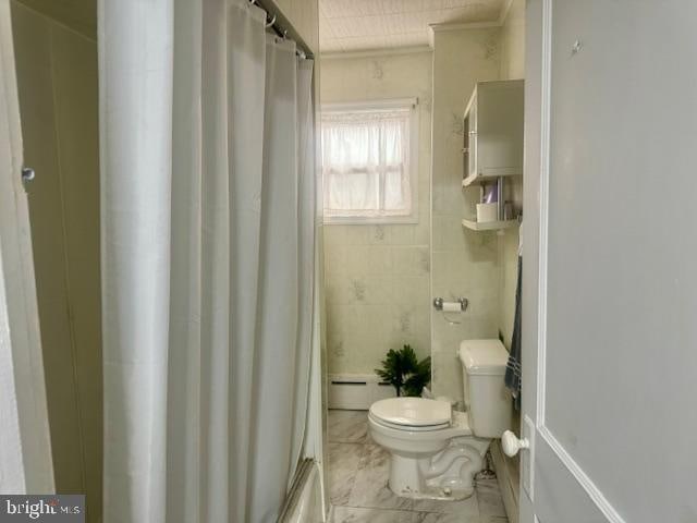 bathroom with shower / bath combo, toilet, baseboard heating, and crown molding