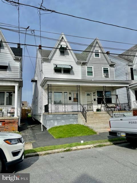 townhome / multi-family property featuring a porch