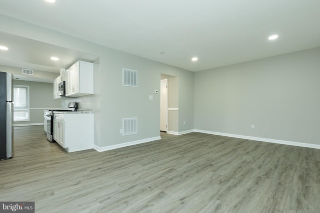 unfurnished living room featuring light hardwood / wood-style flooring