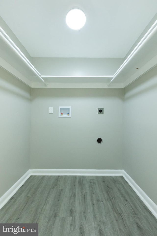 clothes washing area featuring hardwood / wood-style floors, washer hookup, and hookup for an electric dryer