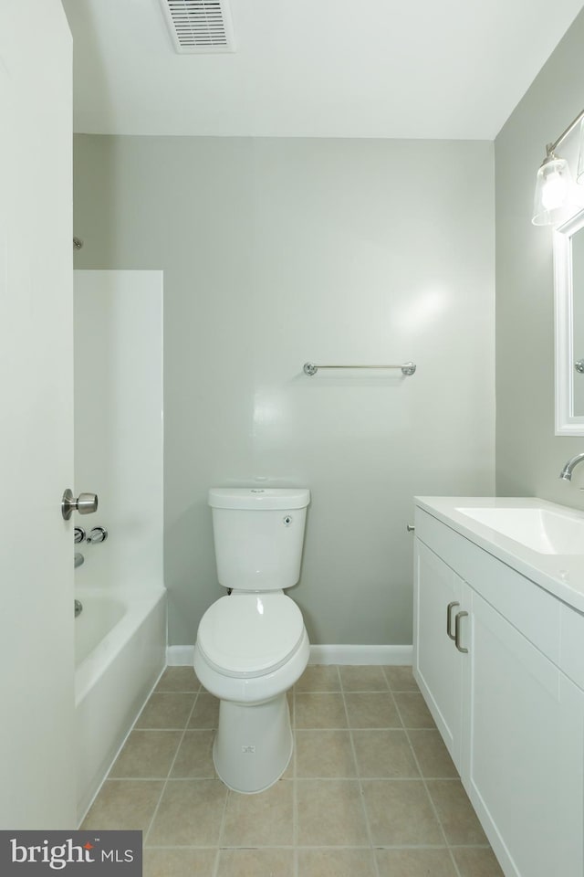 bathroom with tile patterned floors, vanity, and toilet