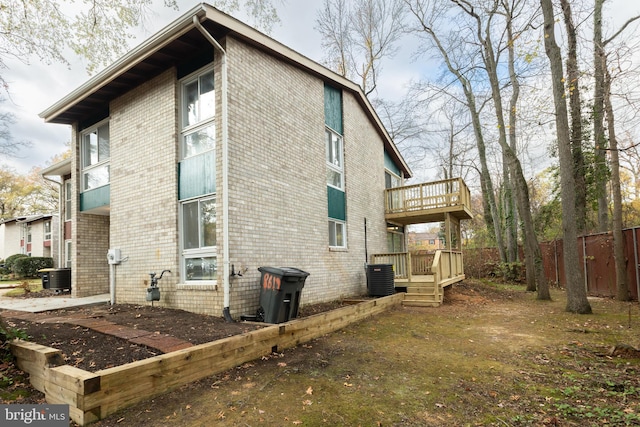 view of side of home featuring central air condition unit and a deck