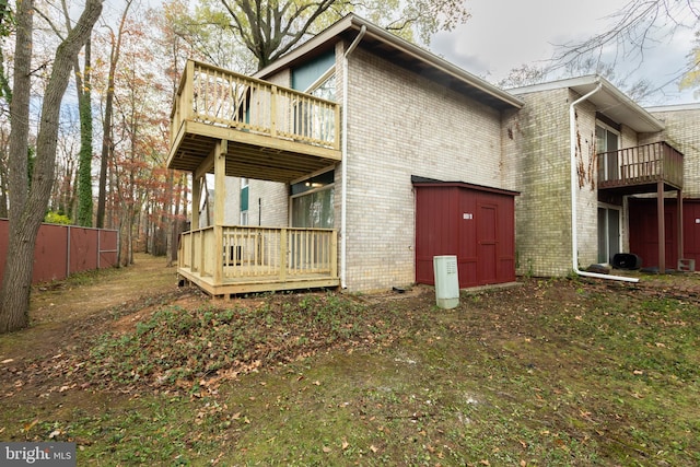 rear view of house with a storage unit