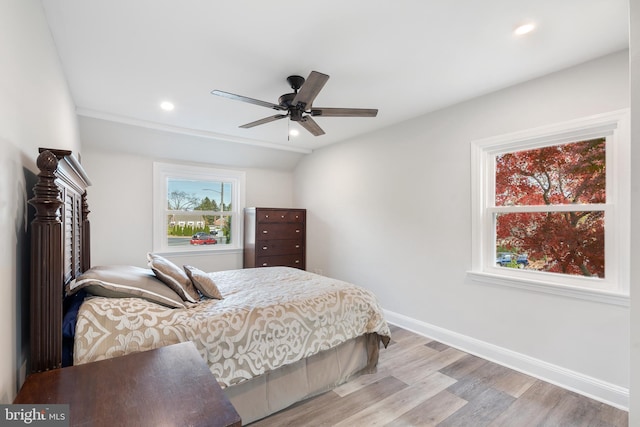 bedroom with ceiling fan and light hardwood / wood-style flooring