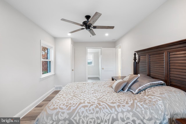 bedroom with wood-type flooring and ceiling fan