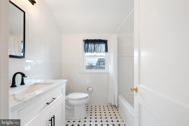 full bathroom featuring vanity, tile patterned flooring, toilet, tile walls, and shower / tub combo with curtain